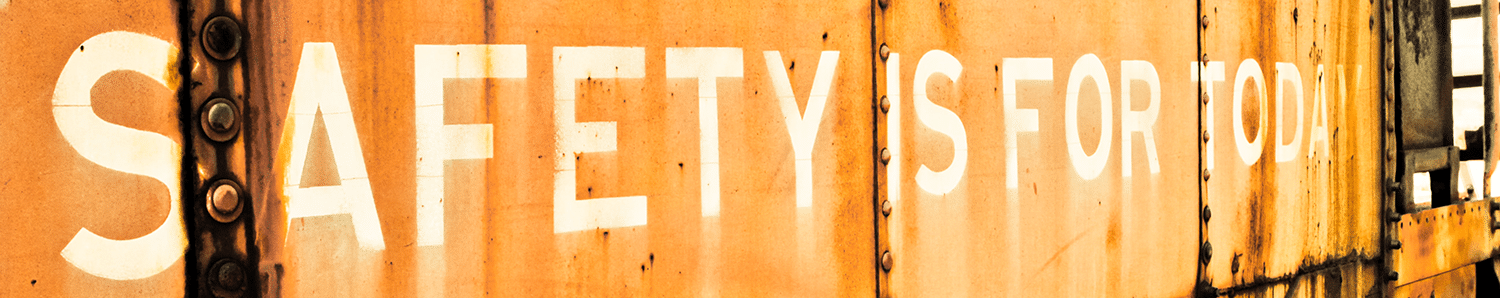Safety is for Today in white spray paint on a rusty railroad car
